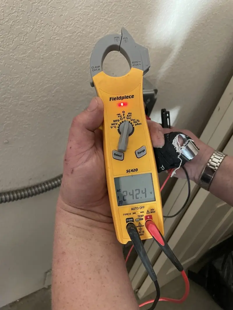 Voltage testing with clamp meter during Recessed Lighting Installation in New London